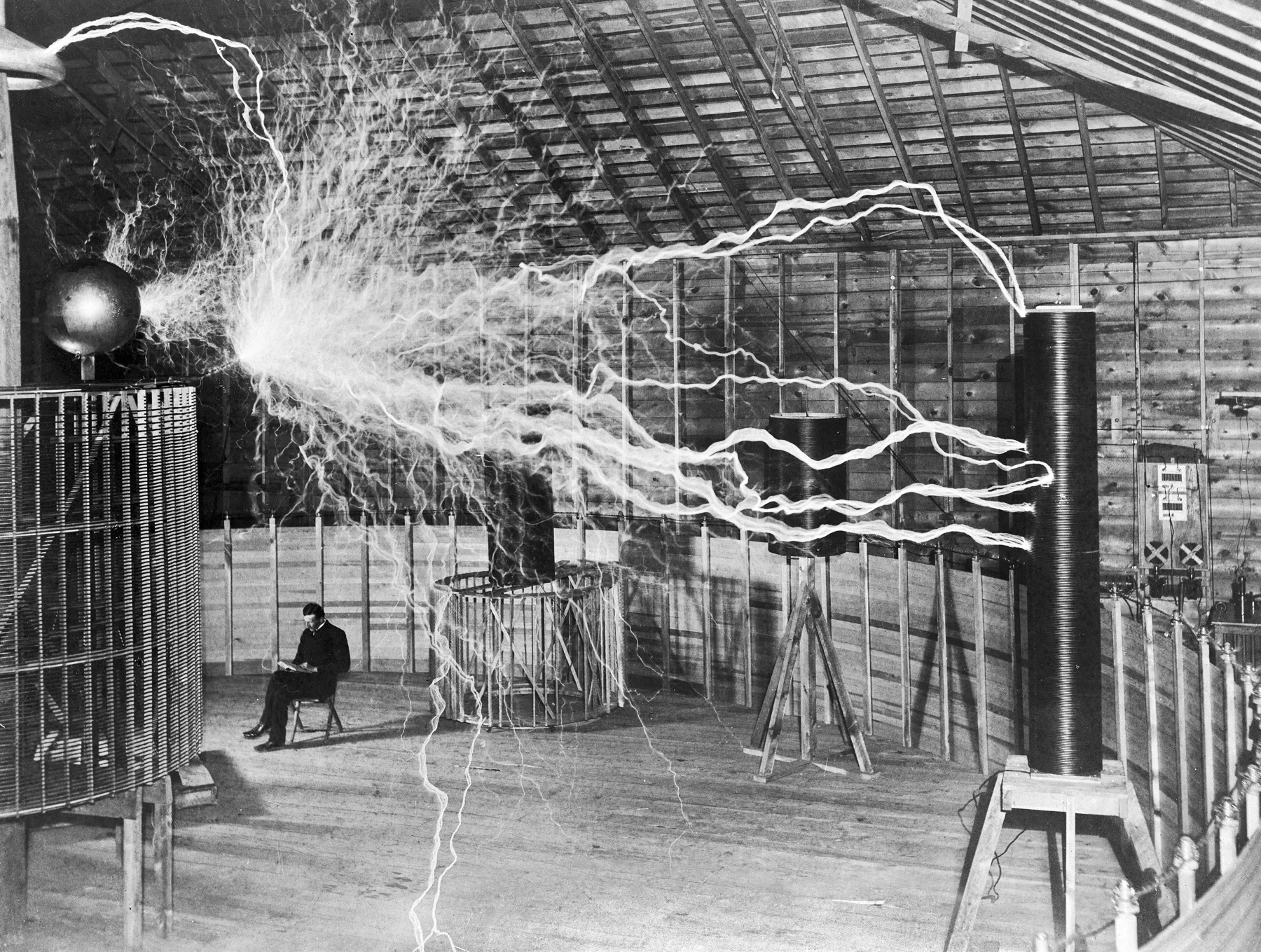 Nikola Tesla in his Colorado Springs laboratory, c. 1899: a deliberate double-exposure publicity photograph